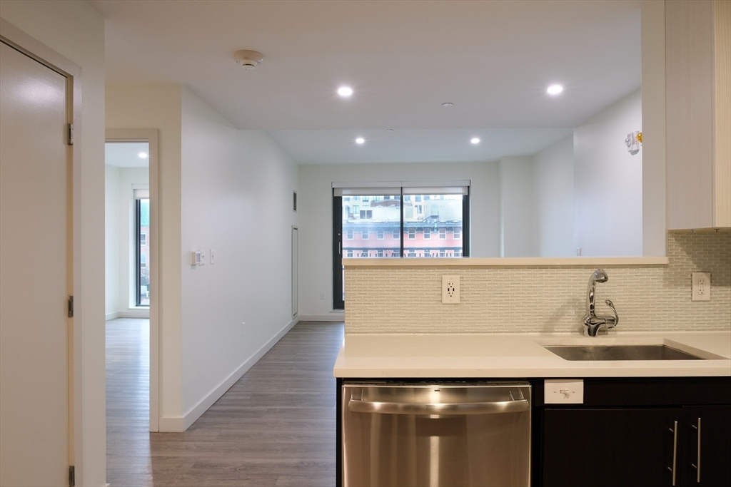 a kitchen with a sink and a refrigerator