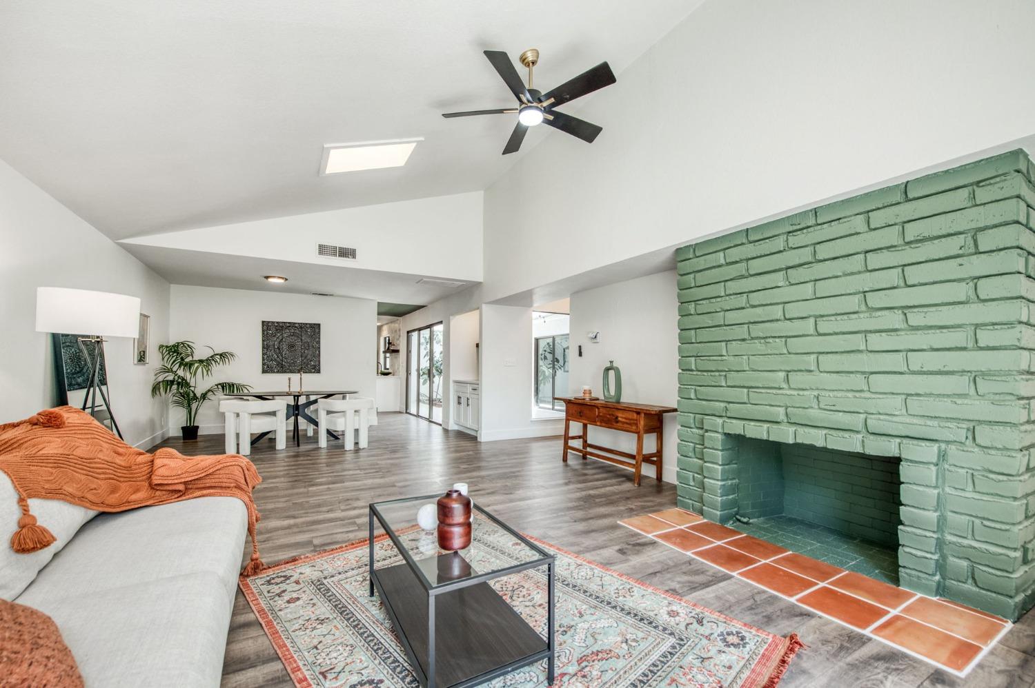 a living room with furniture a fireplace and a table