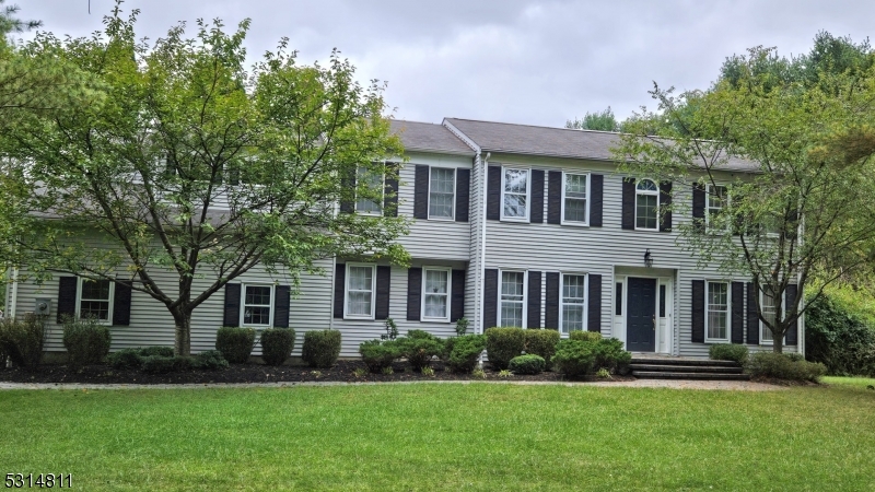 front view of a brick house with a yard