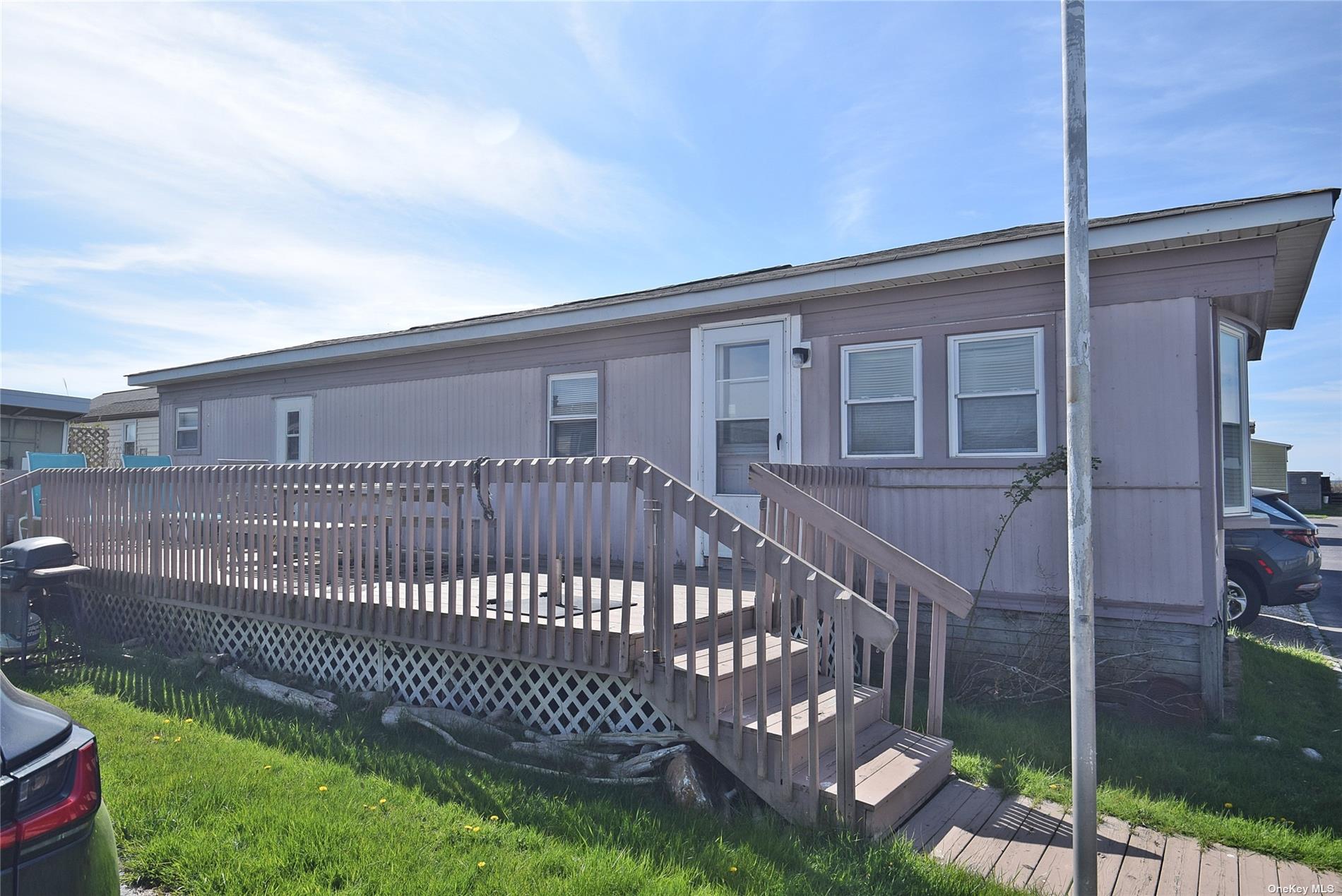 a view of a house with a small yard and wooden fence