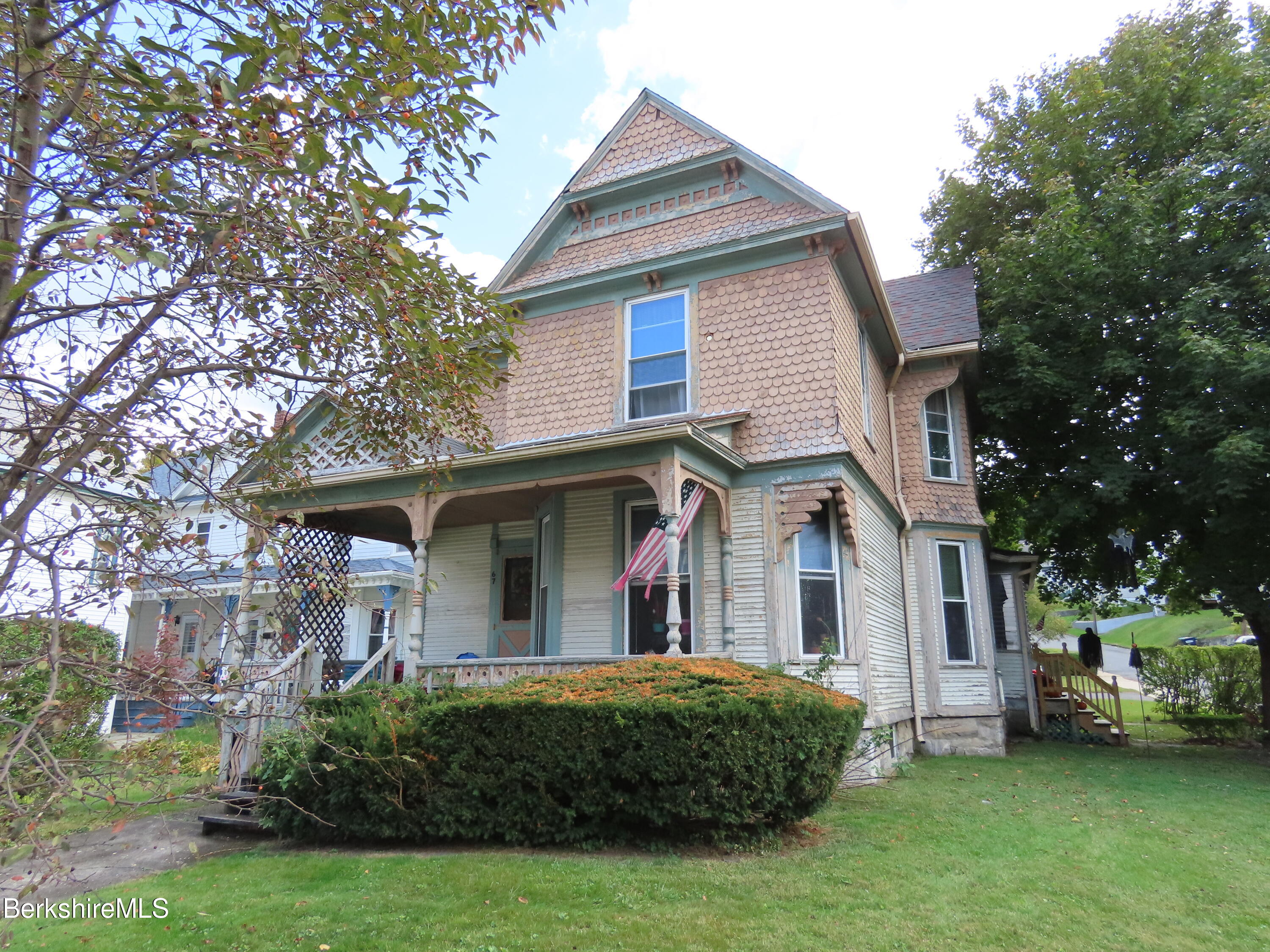 a front view of a house with a garden