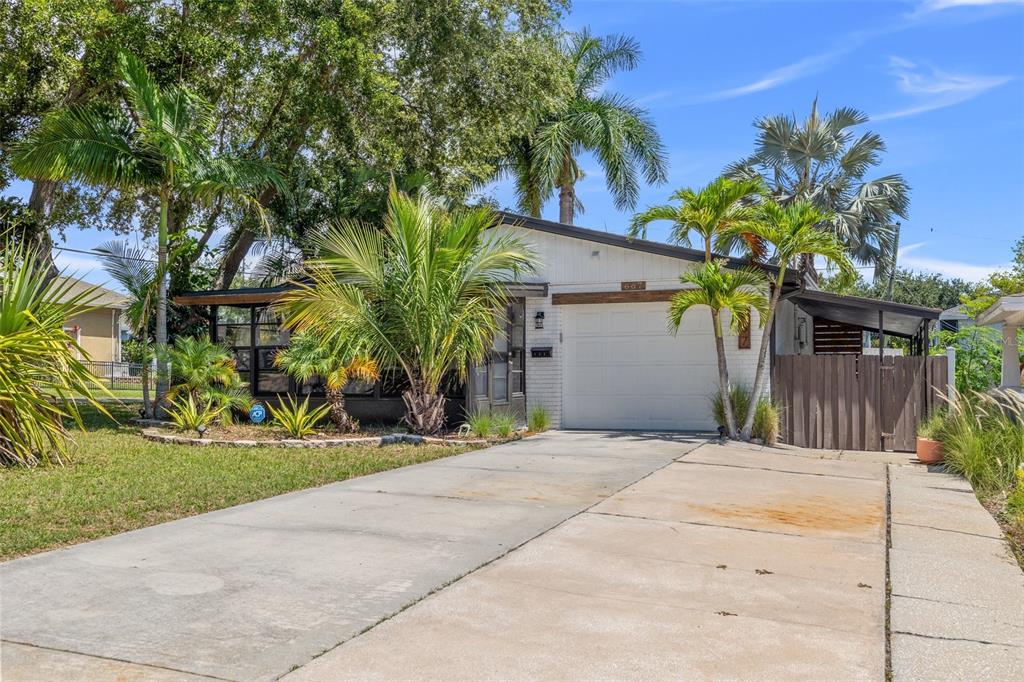 a front view of a house with a yard and a garage