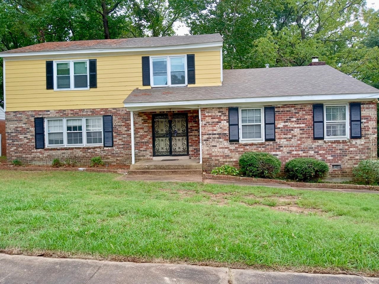 a front view of a house with a yard