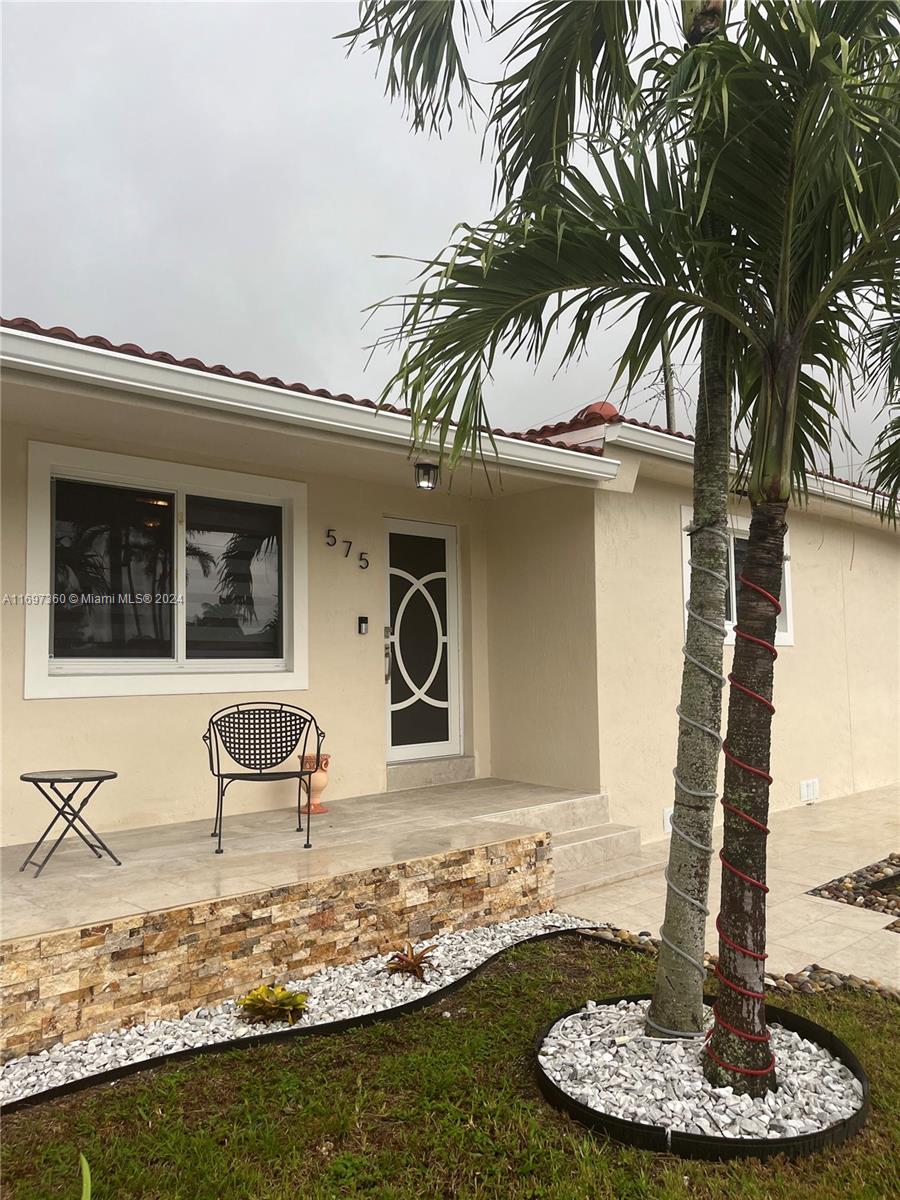 a front view of a house with a yard fire pit and outdoor seating