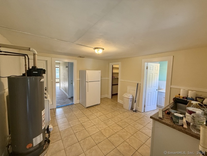 a kitchen with stainless steel appliances granite countertop a refrigerator and a stove