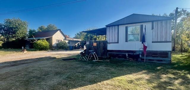 a view of house with backyard