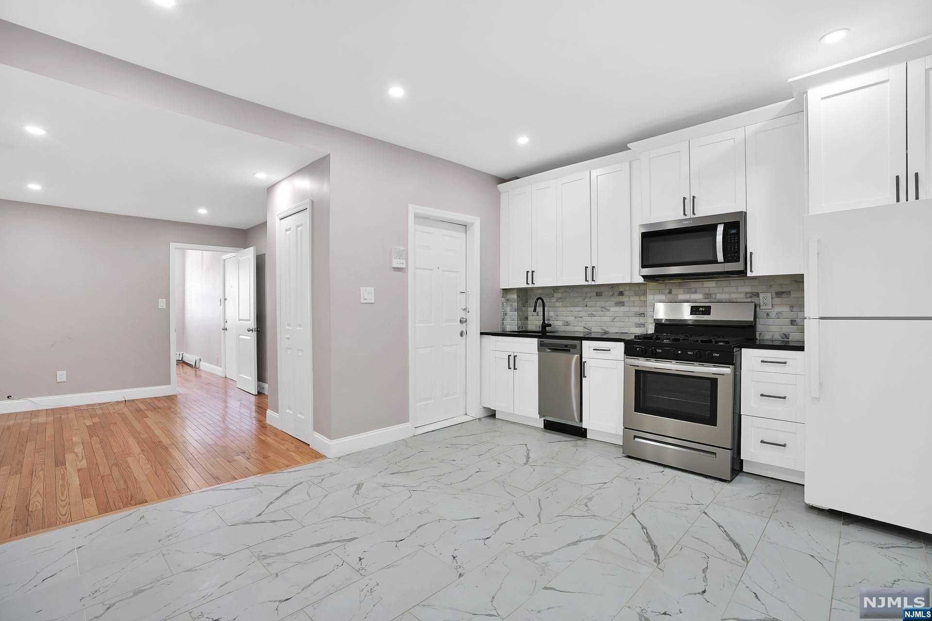 a kitchen with granite countertop a stove and a refrigerator