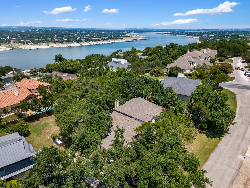 an aerial view of ocean and residential houses with outdoor space and ocean view