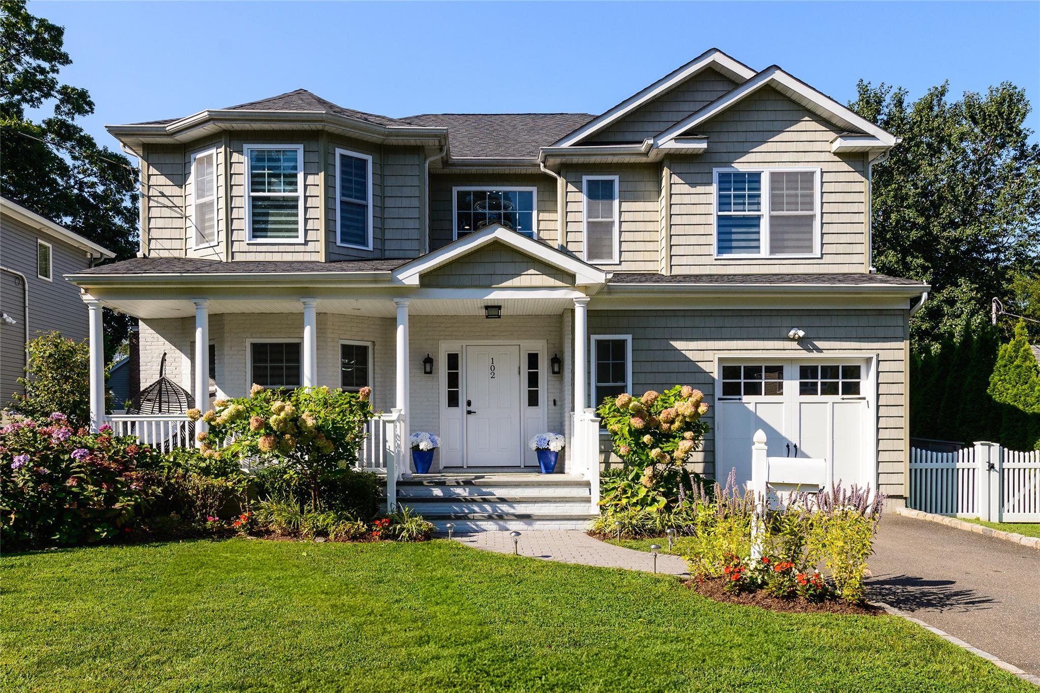 View of front of property featuring a garage and a front yard