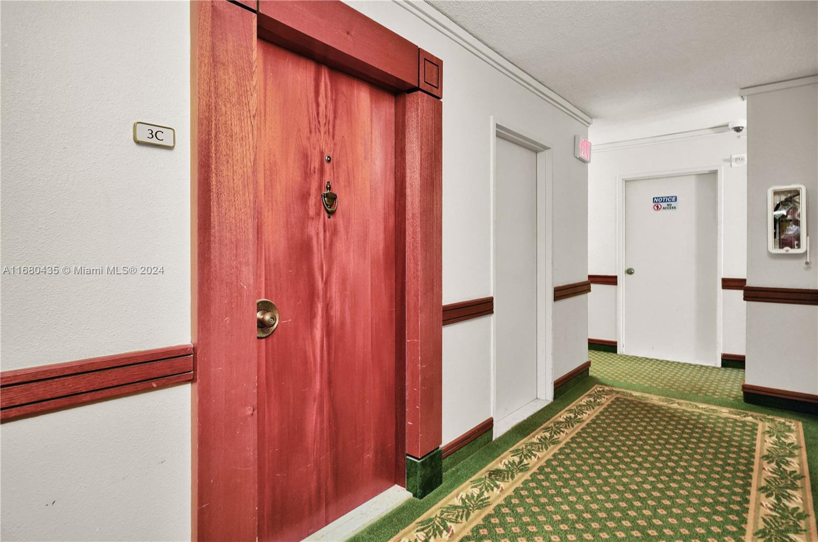 a view of a closet area with hardwood floor