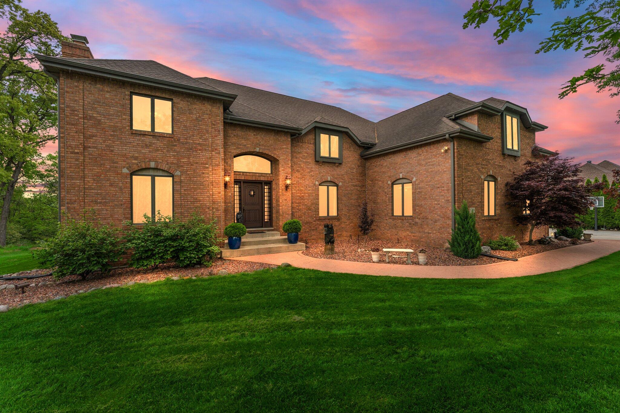 a front view of a house with swimming pool having outdoor seating