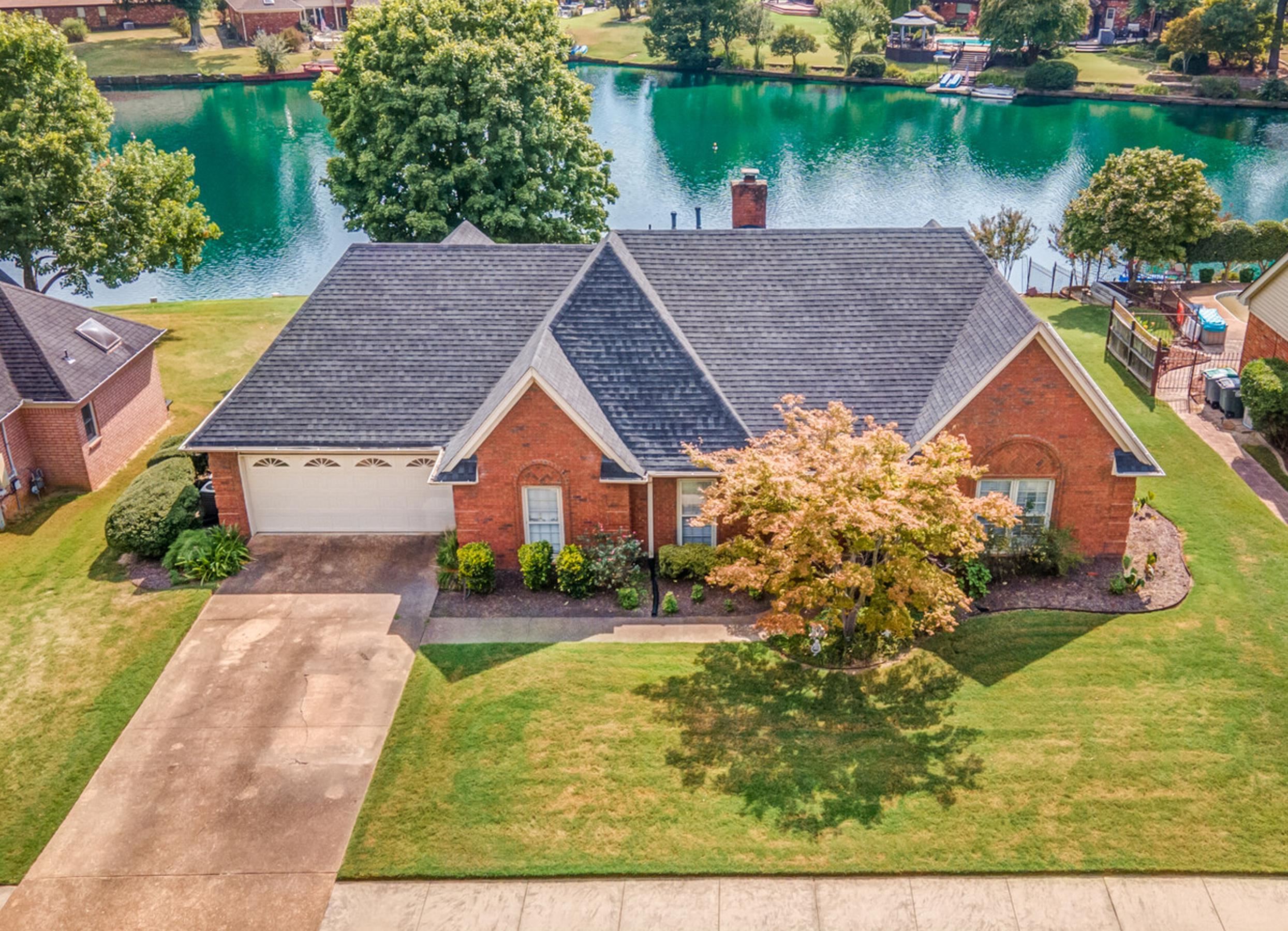 aerial view of a house with a yard