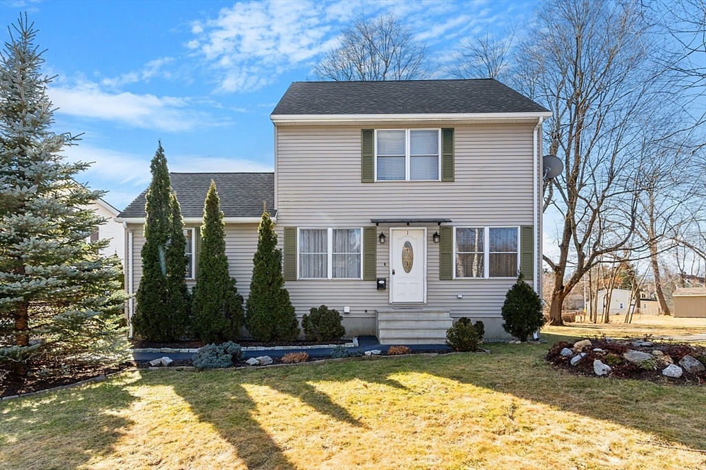 a view of a house with backyard and sitting area