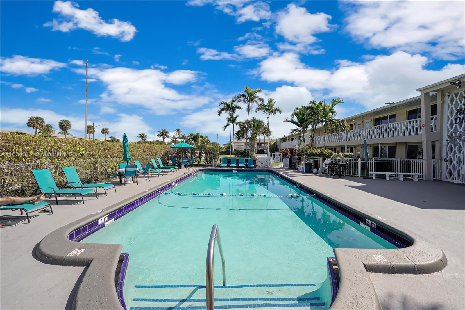 a view of a swimming pool with outdoor seating