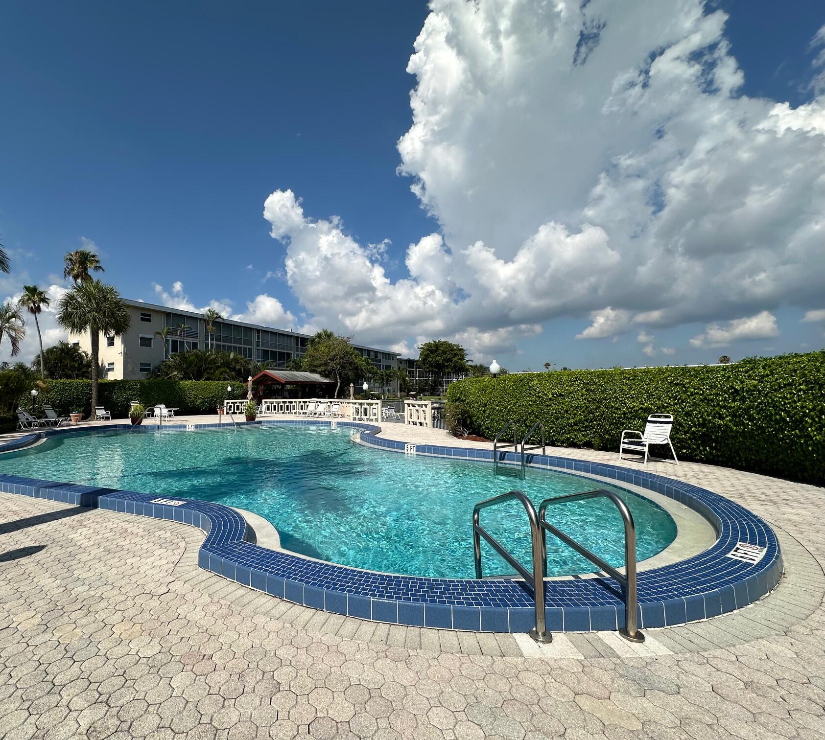 a swimming pool with outdoor seating and yard