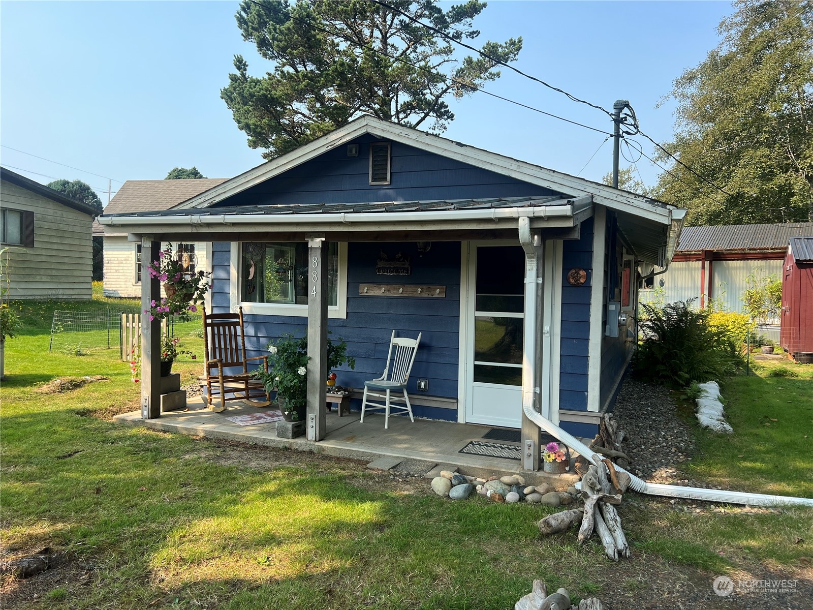 a view of a house with backyard porch and sitting area