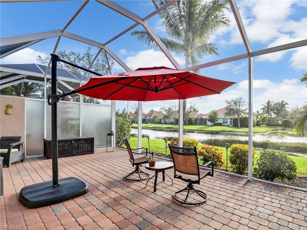 a view of a table and chairs under an umbrella in patio with a fire pit