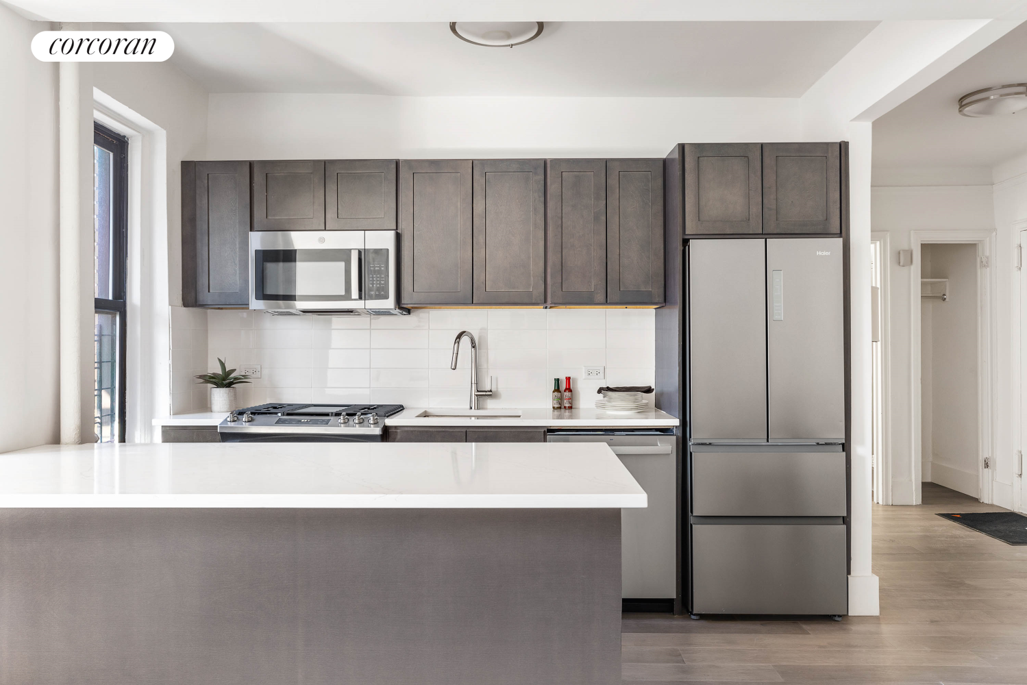 a kitchen with a refrigerator sink and microwave