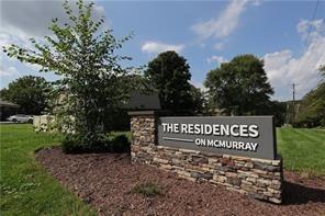 a view of outdoor space with sign board and garden