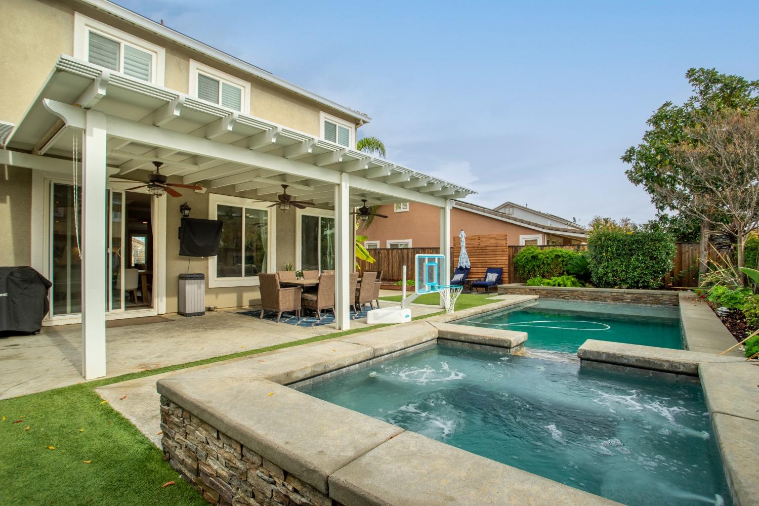 a view of a house with backyard porch and sitting area