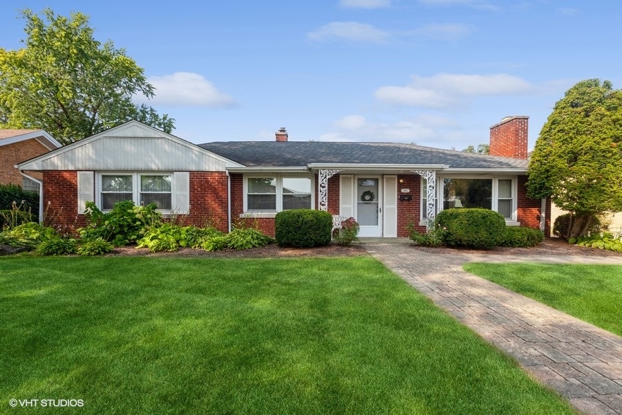 a view of a house with a yard and plants