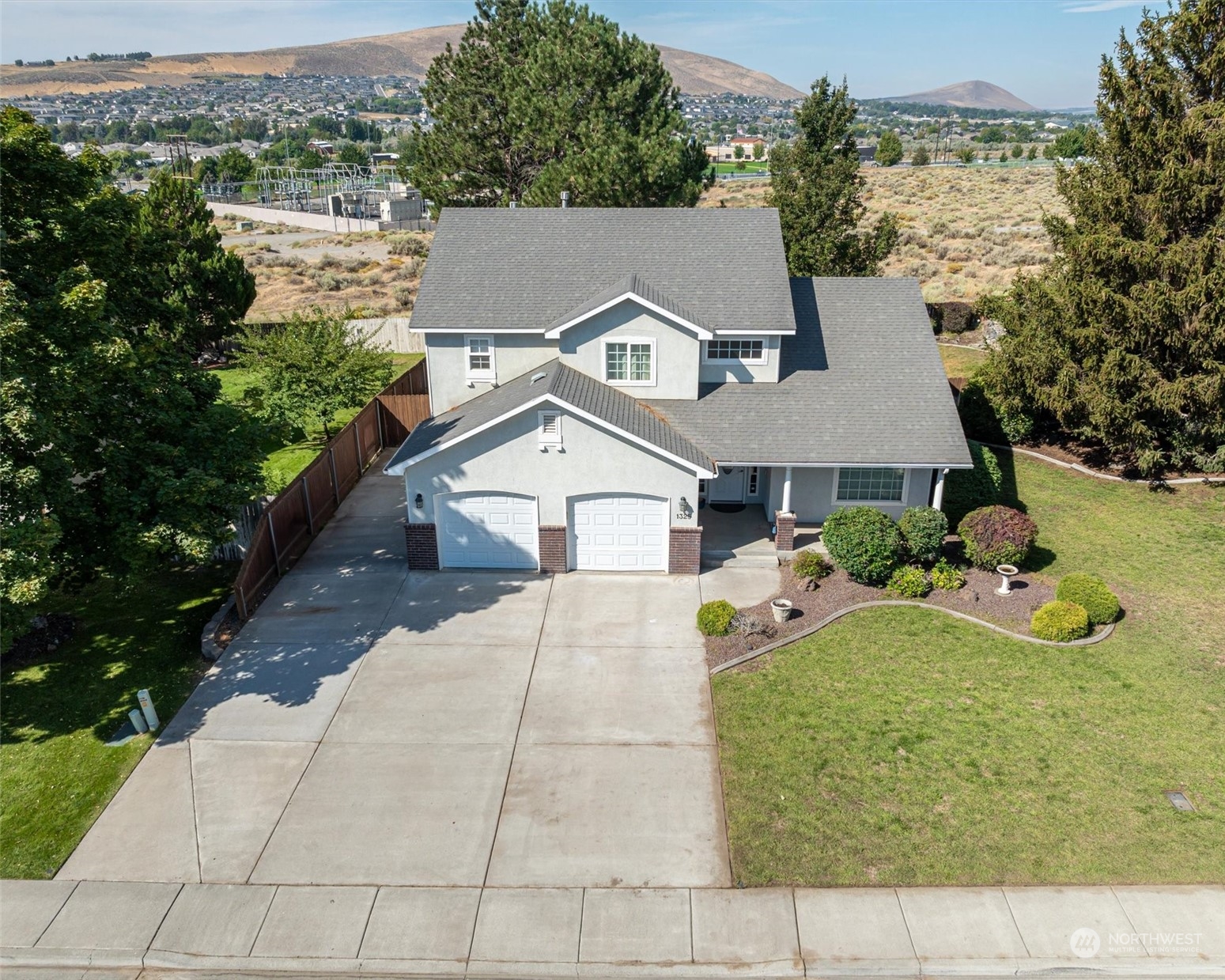 an aerial view of a house with a yard