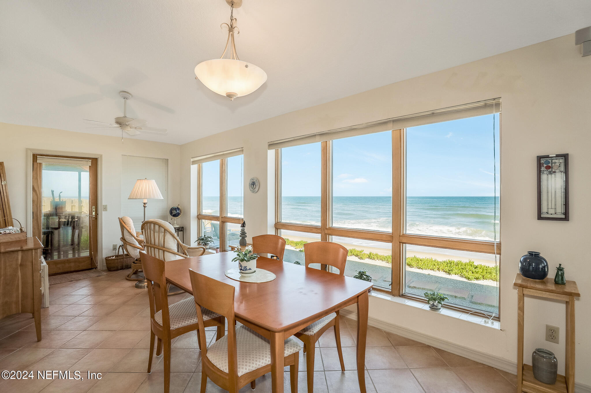 a view of a dining room with furniture large windows and wooden floor