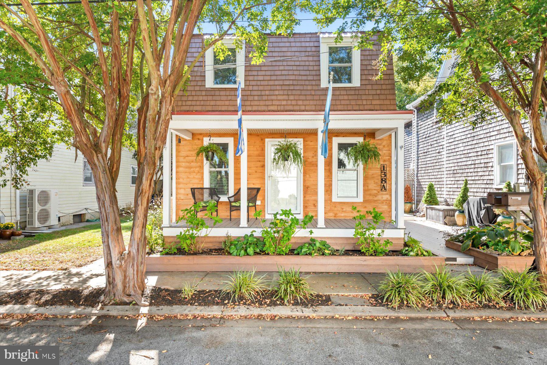 a front view of a house with a yard and fountain