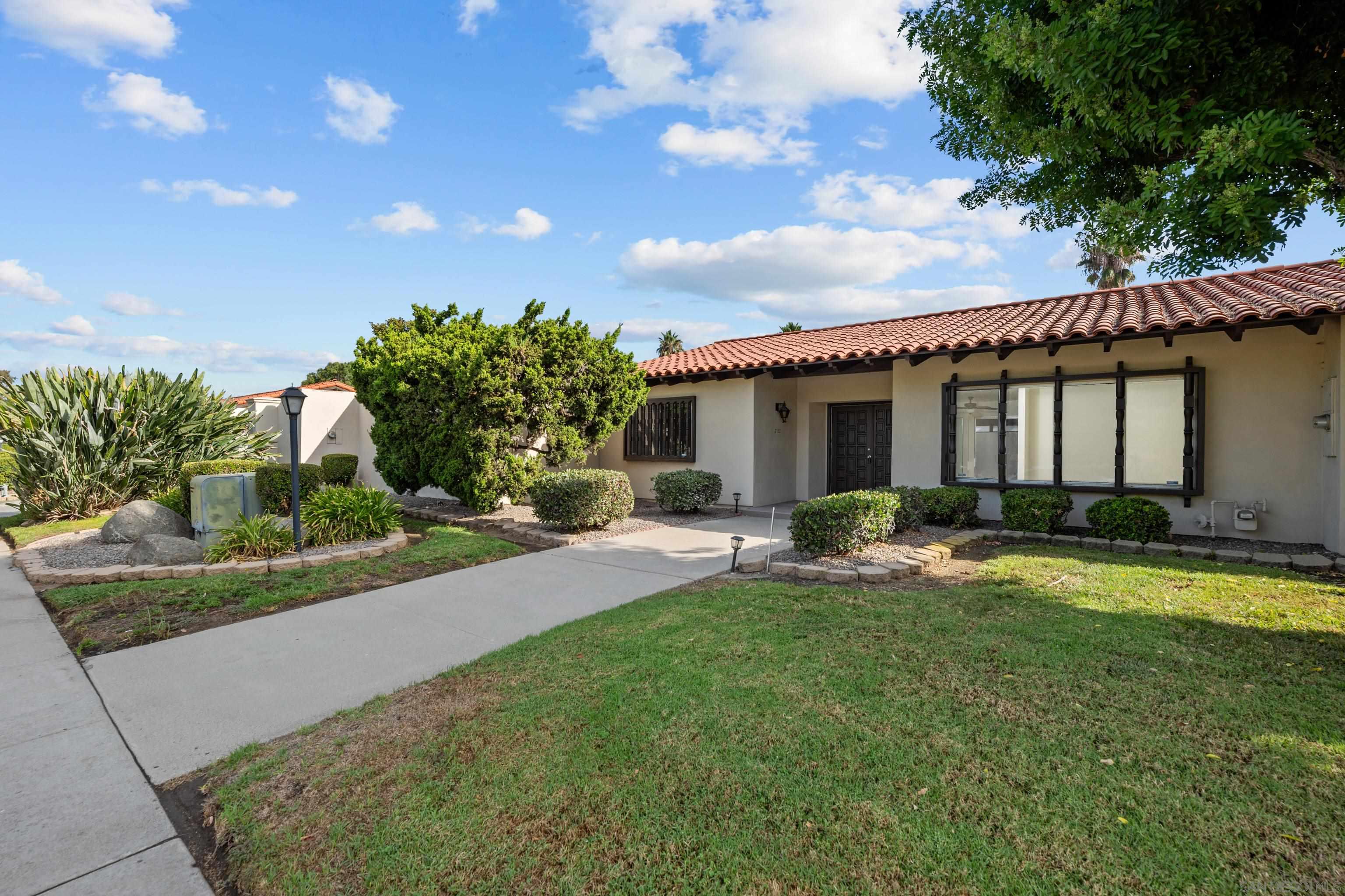 a front view of house with yard and outdoor seating