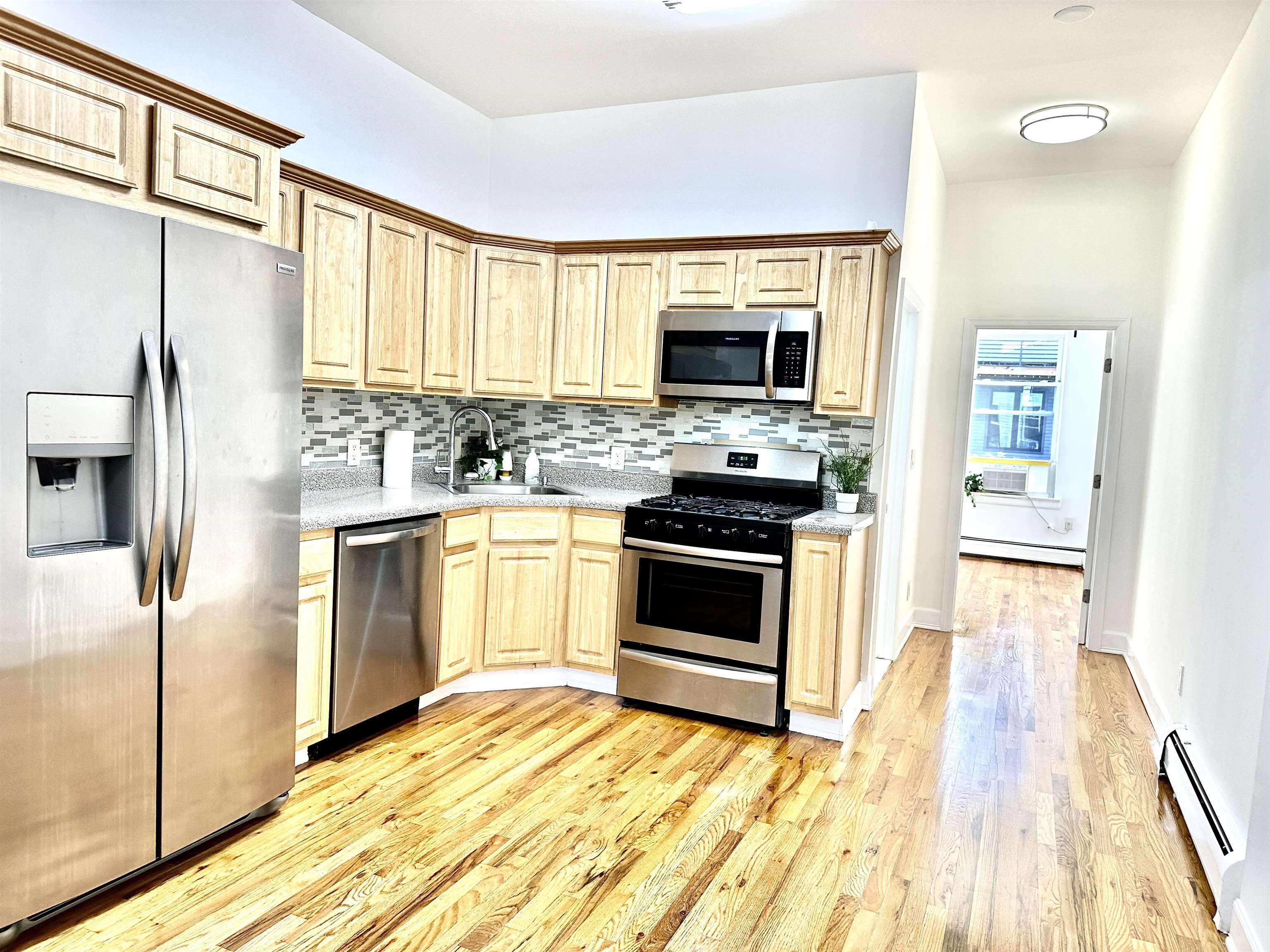 a kitchen with stainless steel appliances a stove top oven and refrigerator