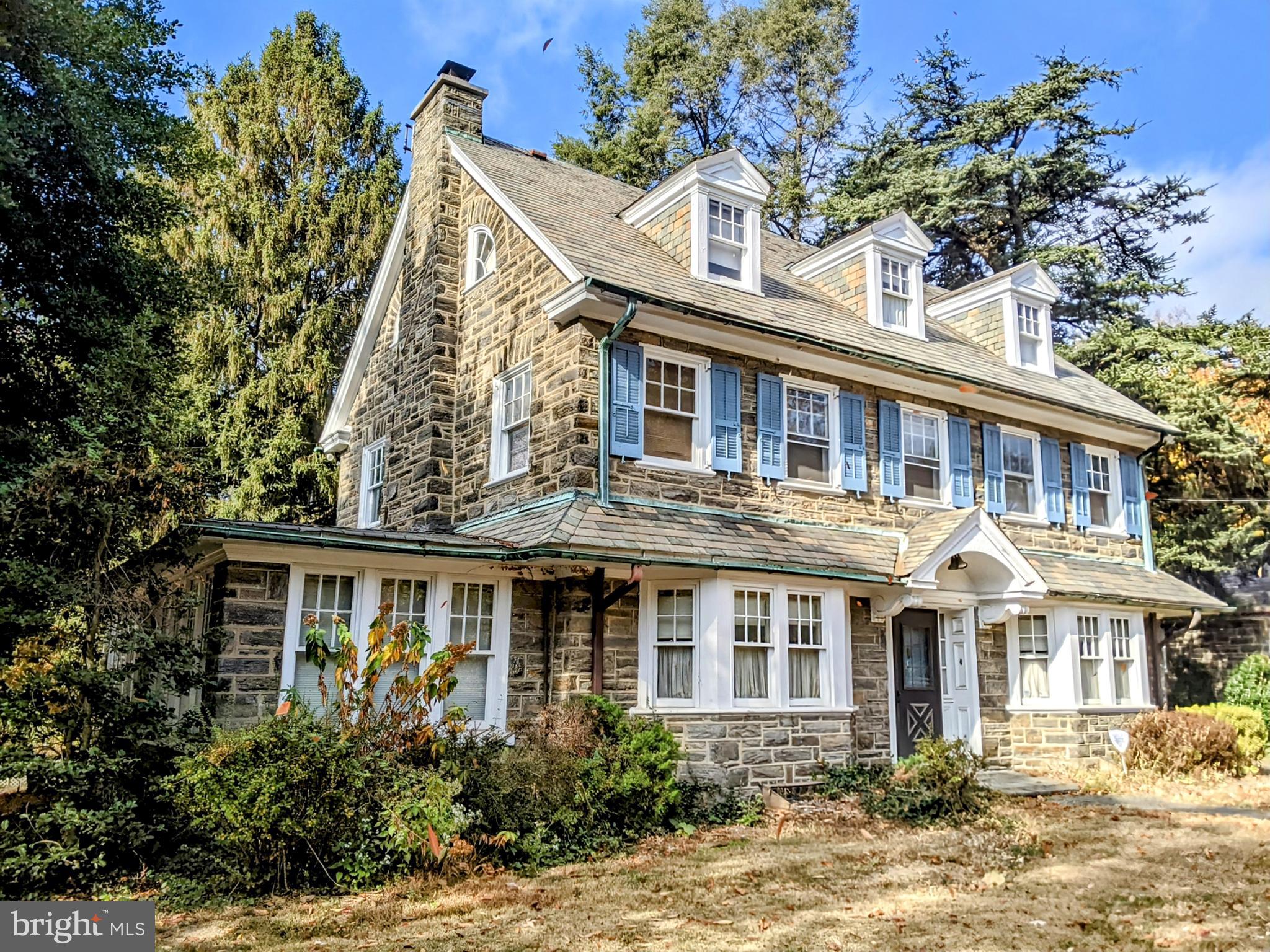 a front view of a house with a yard and potted plants