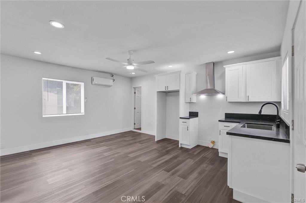 a kitchen with stainless steel appliances a refrigerator sink and cabinets