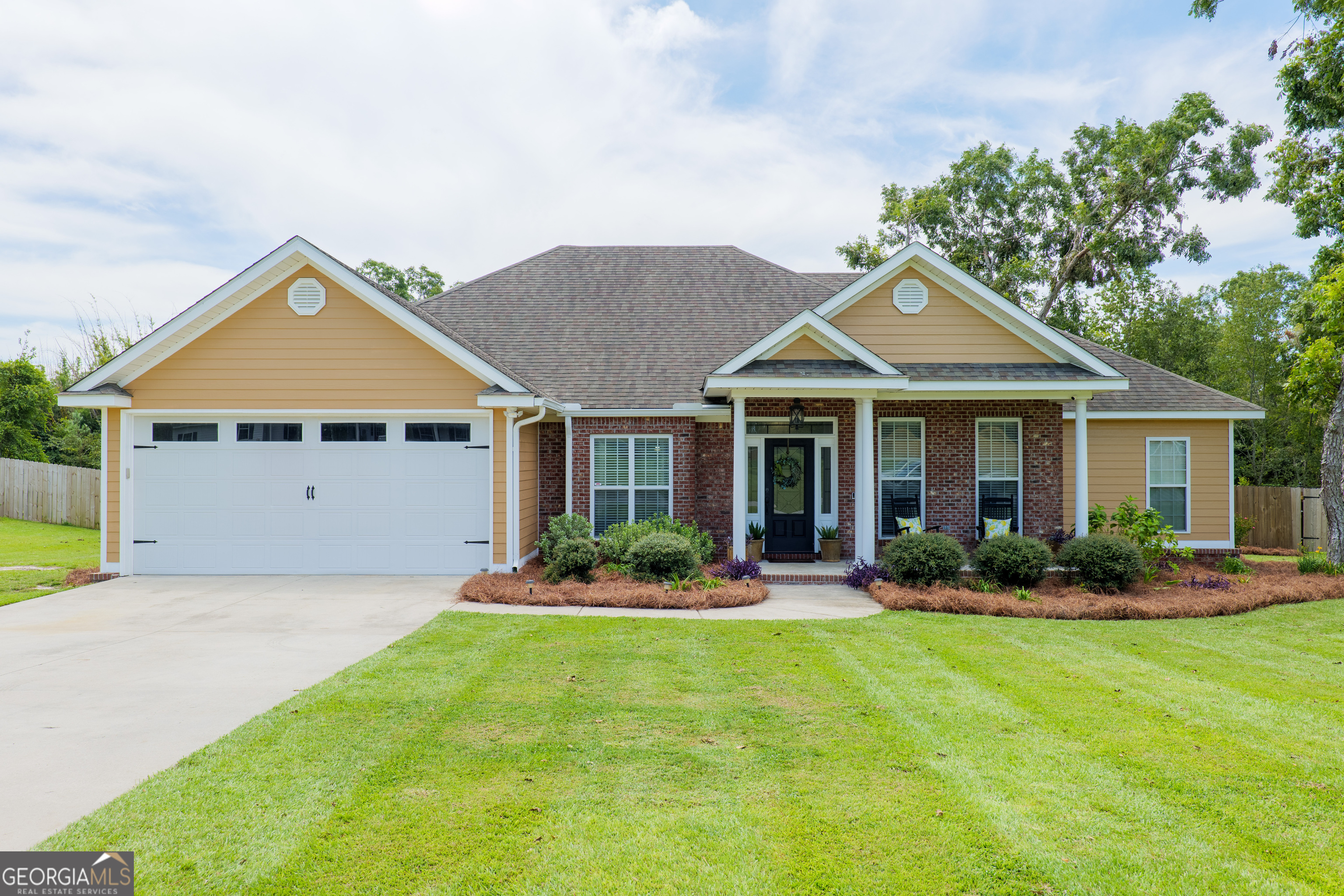 a front view of a house with a yard and porch