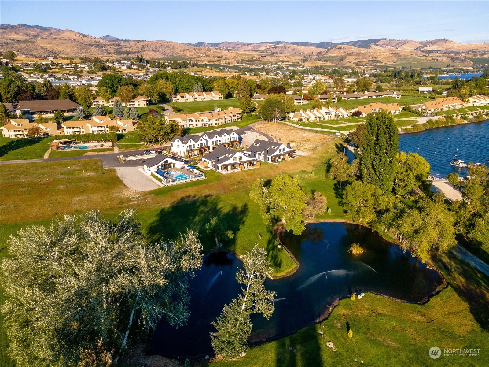 an aerial view of residential houses with outdoor space