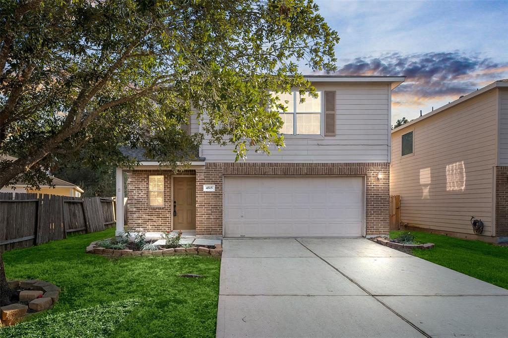 a front view of a house with a yard and a garage