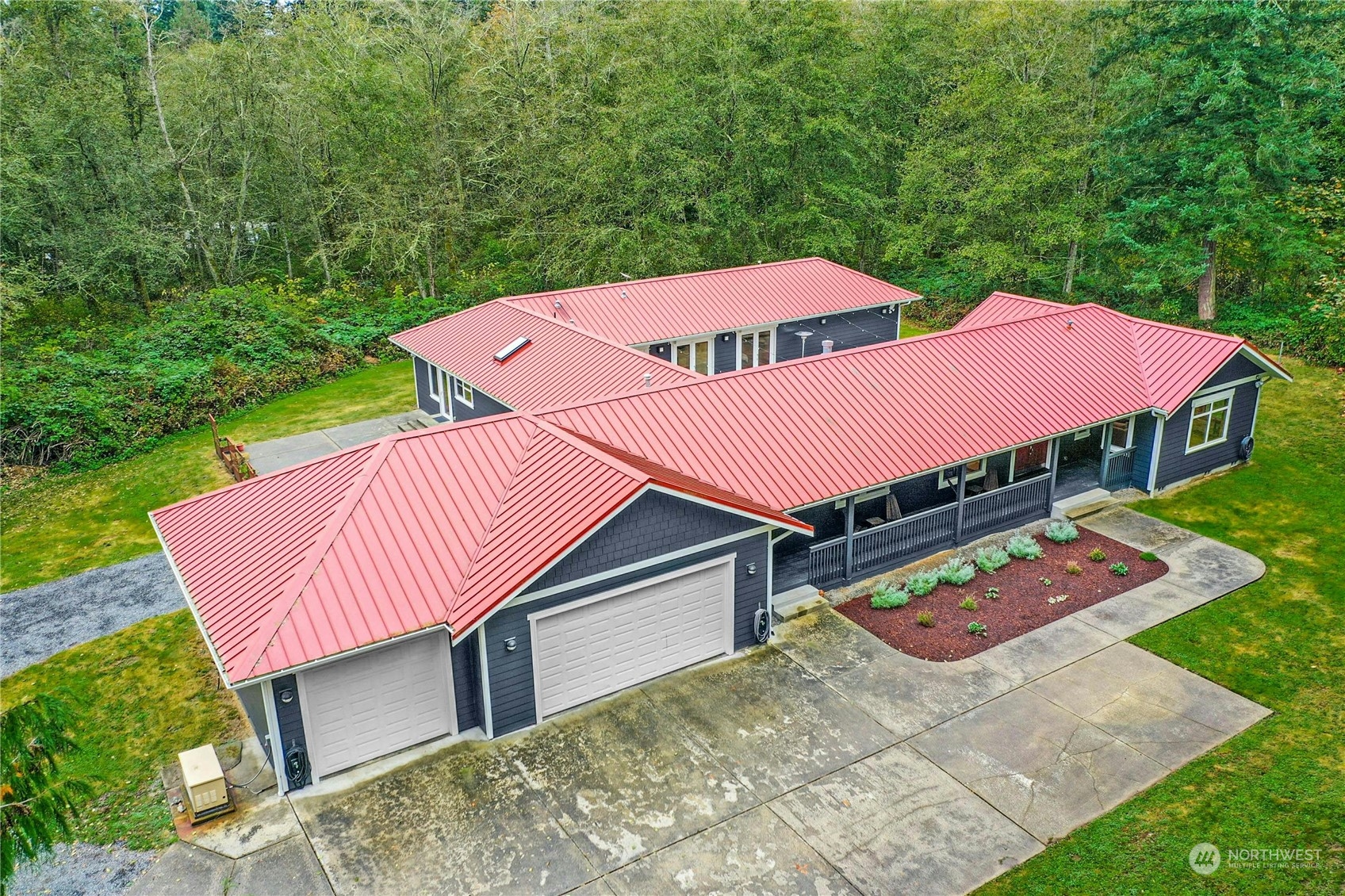 an aerial view of a house with swimming pool and red chairs