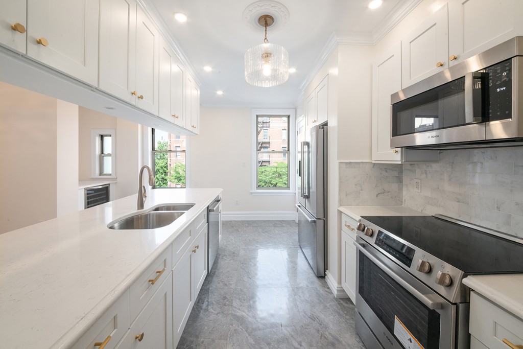 a kitchen with a sink stove and microwave