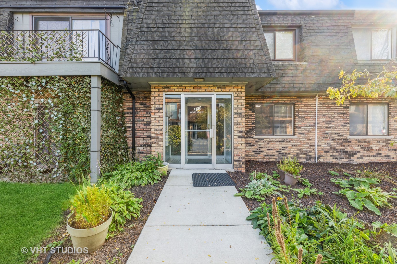 a front view of a house with a garden