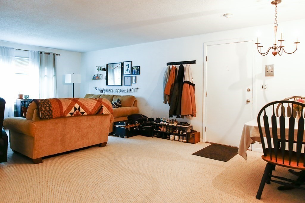 a living room with furniture a air conditioner and a window