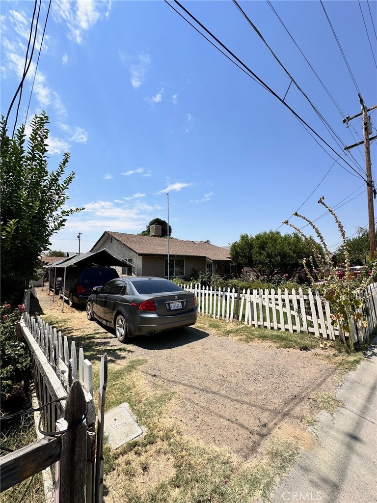 a view of balcony with a car parked on the road