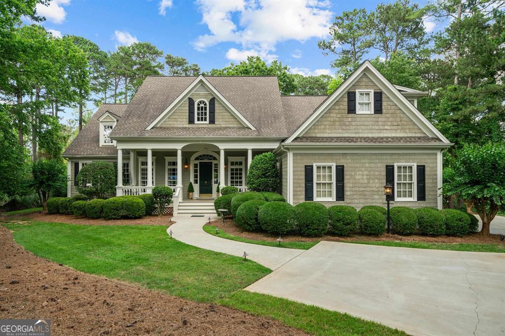 a front view of a house with a yard and potted plants