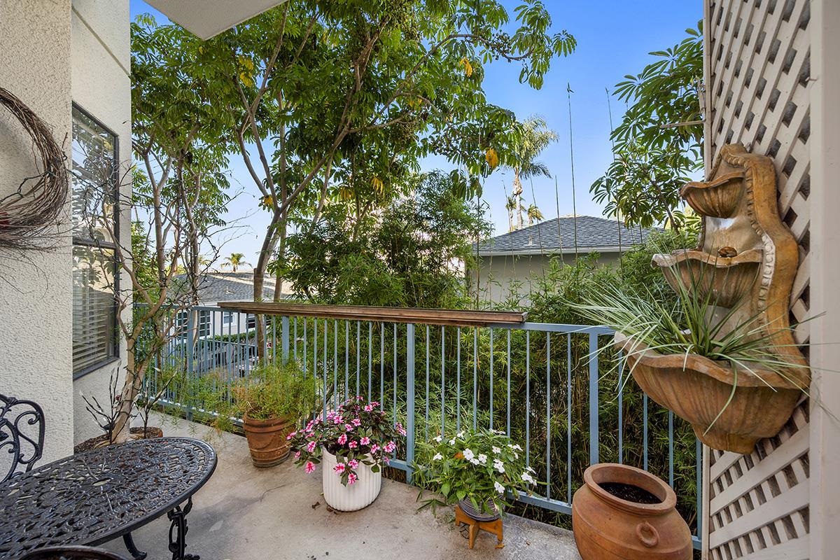 a view of a chairs and table in the balcony