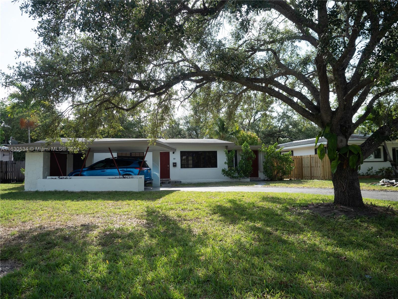 a view of a backyard with a garden and trees