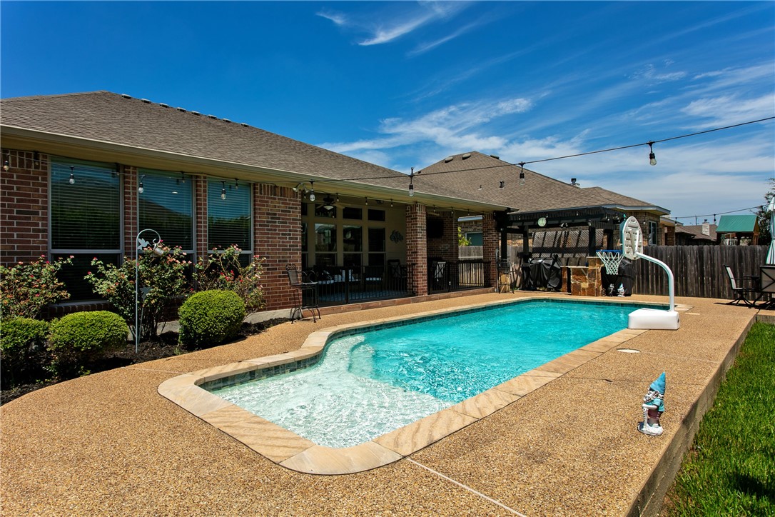 a view of a house with backyard porch and sitting area