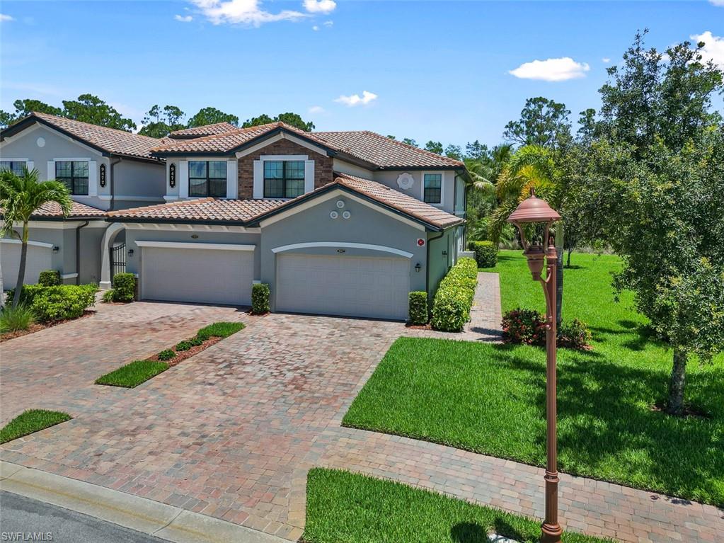 a front view of a house with a garden and a yard