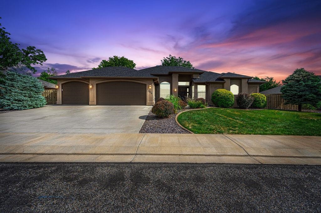 a front view of a house with a yard and garage