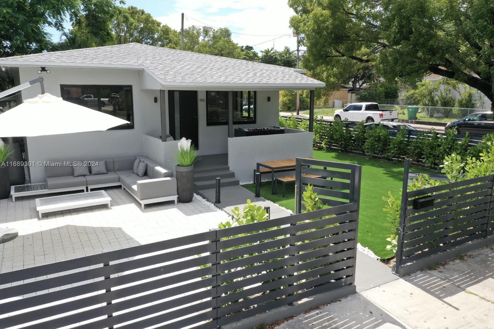 a view of a patio with table and chairs potted plants with wooden fence