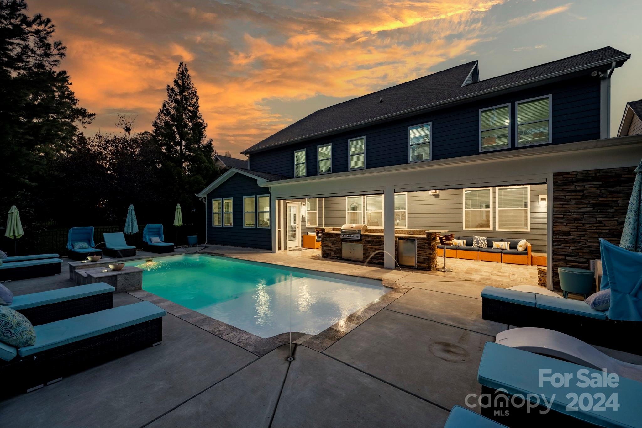 a view of a house with backyard porch and sitting area