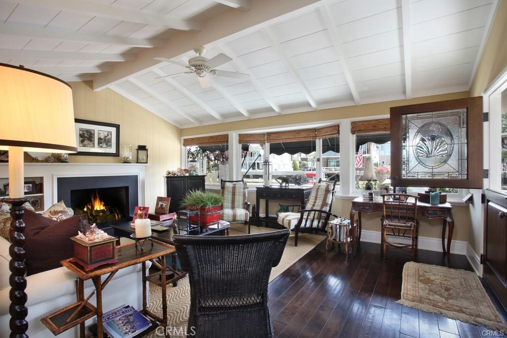 a living room with fireplace furniture and a large window