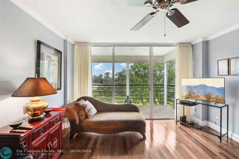 a living room with furniture and a floor to ceiling window